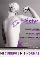 The sticker portrays the back of a naked woman with her right arm raised and her hand fisted upward. Her long blonde hair is tied up in a bun and her left arm sits at her side. On the bottom there is a purple star, which is the logo for the Anticapitalist Left Party in Spain. 